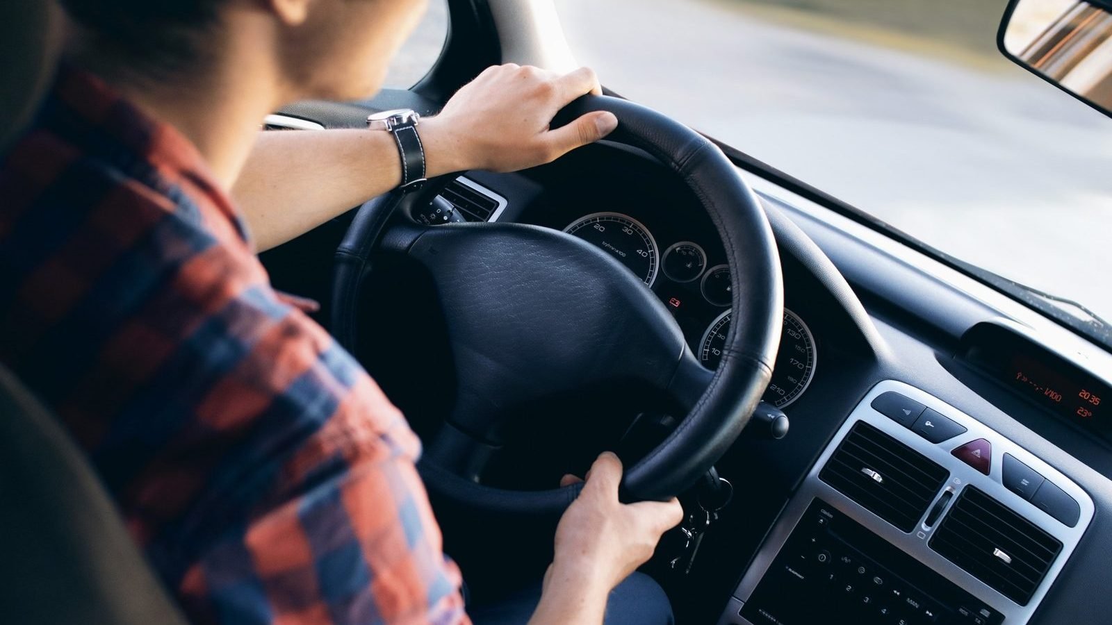 Close-up of a driver at the wheel of a car