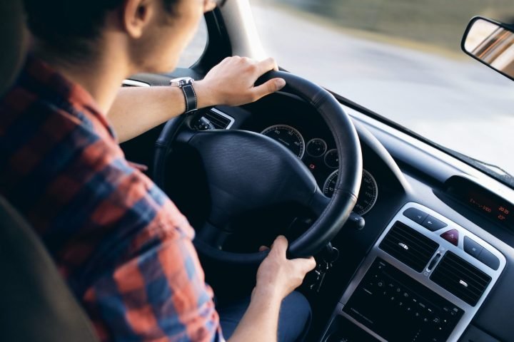 Close-up of a driver at the wheel of a car