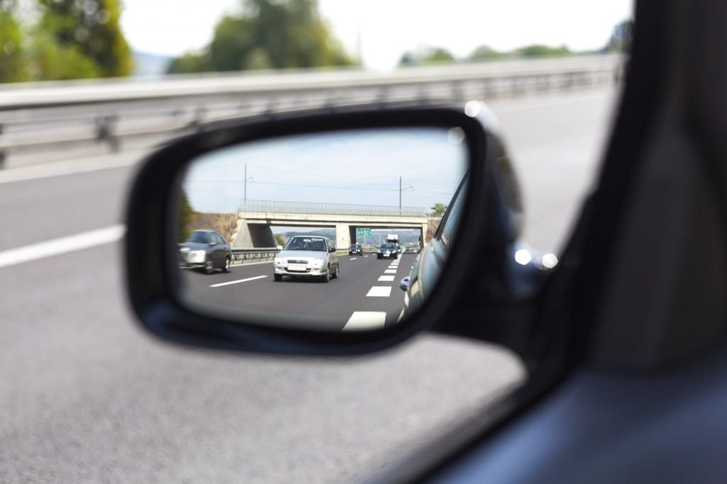 Motorway traffic seen in a car wing mirror