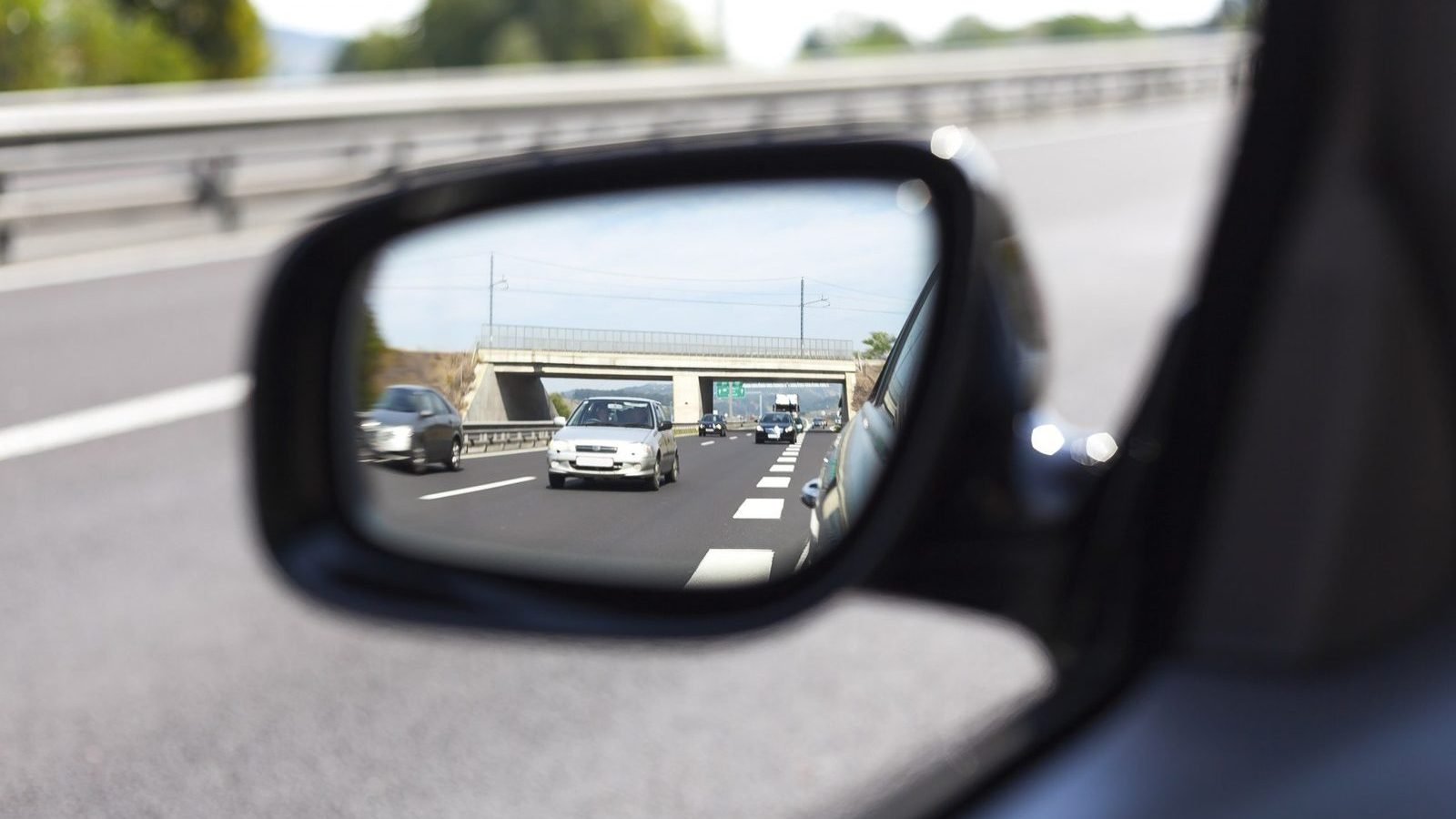 Motorway traffic seen in a car wing mirror