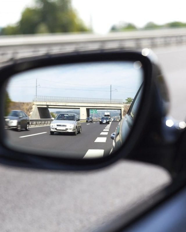 Motorway traffic seen in a car wing mirror